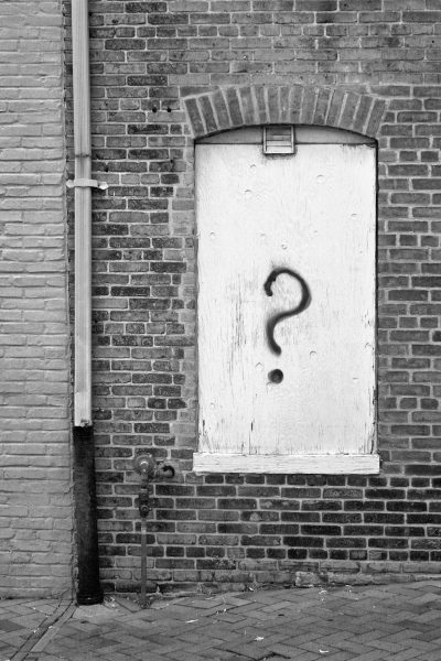 Photo by John Cardamone A black and white photo of a door with a question mark on it